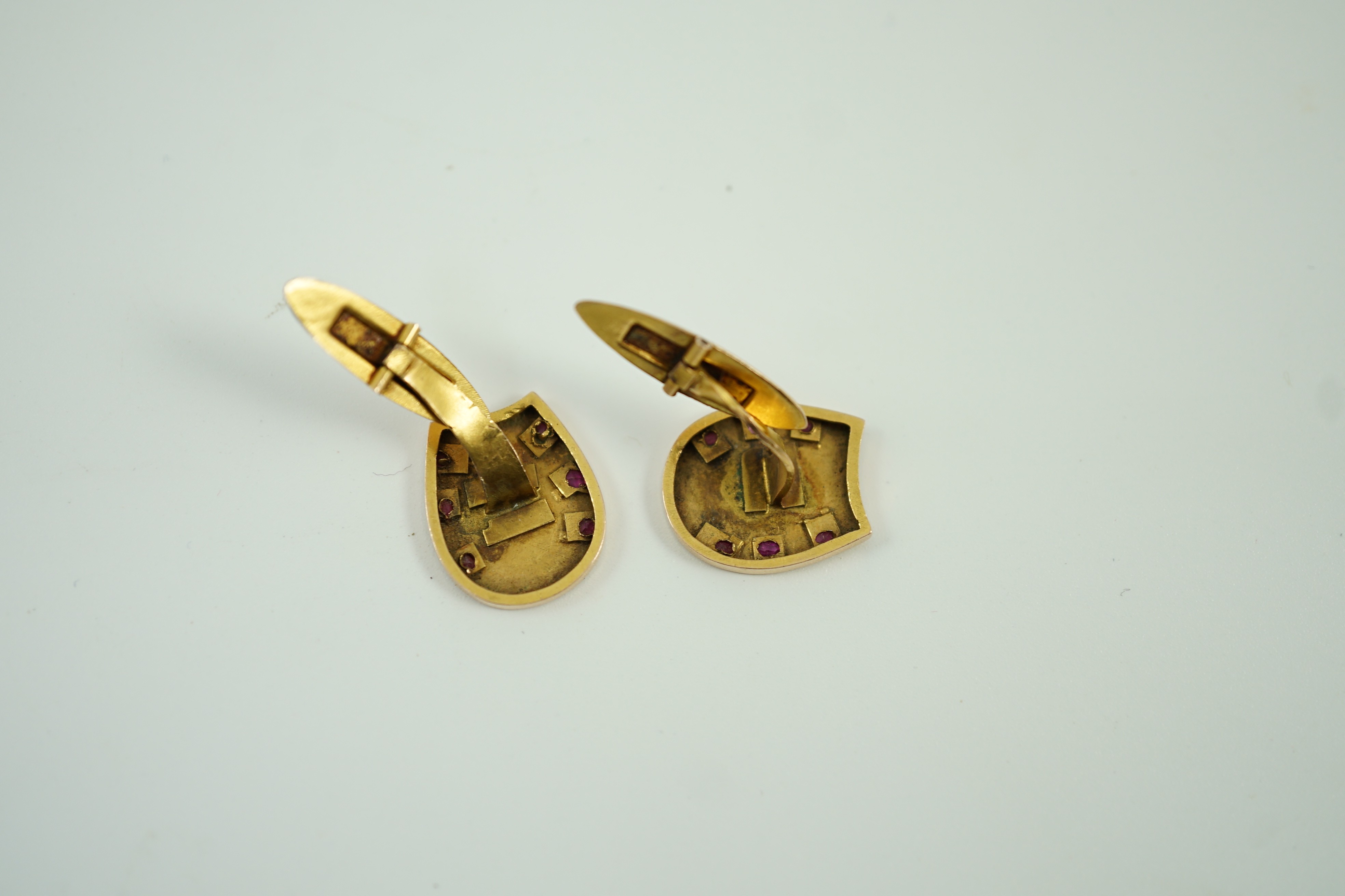 A pair of early 20th century Russian 56 zolotnik yellow metal and ruby set horseshoe shaped cufflinks, 16mm, gross weight 3.9 grams.